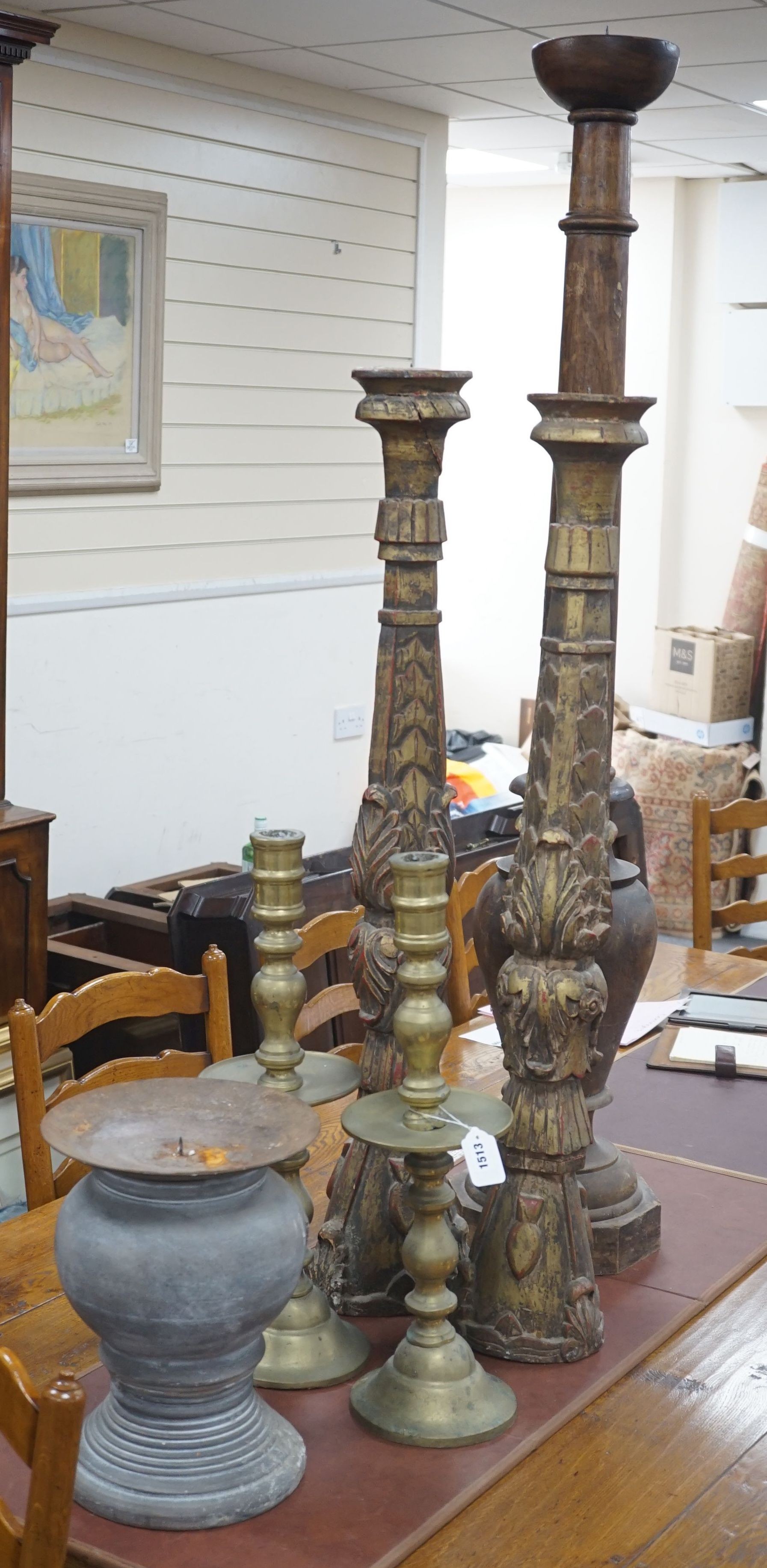 A pair of gilt carved candlesticks, a large turned candlestick, a pair of brass candlesticks and a squat metal candle stick (6), tallest 140cms.